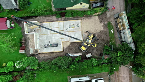 an aerial view of a green landscape and a construction site in a neighbourhood