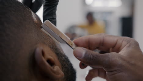 barber shaving a man's head