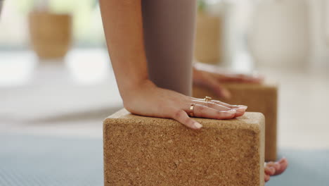 woman practicing yoga with blocks