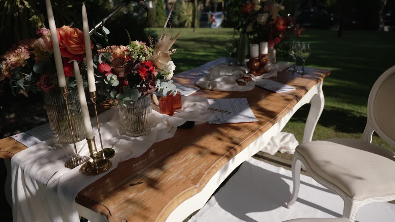 elegant outdoor wedding table with flowers and candles
