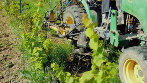 an agricultural machine uproots the weeds growing pesticide-free products organic farming