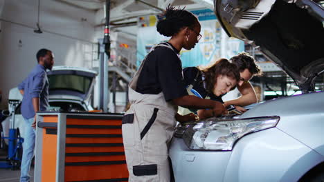 team of mechanics fixing car