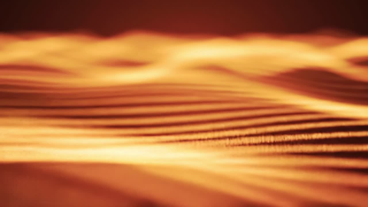 Glowing waves in vibrant orange hues create a mesmerizing visual during an abstract light display. The dynamic patterns evoke a sense of movement and fluidity, captivating the viewer.