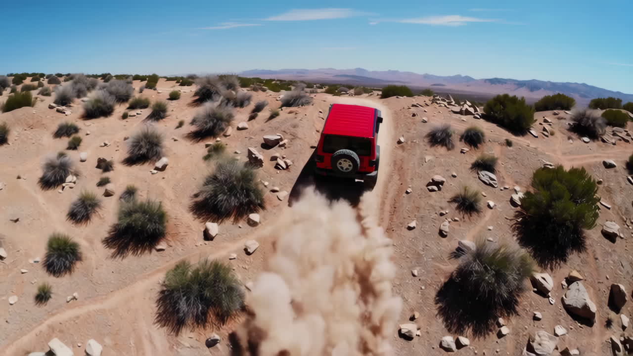 Red Jeep Off-Roading in Desert Landscape