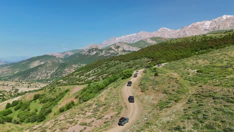 Cars on winding road through scenic hills of Cappadocia, Turkey