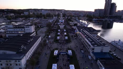 crowds and competitors at the start line of gdynia city night marathon event