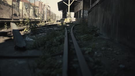 abandoned railway with old warehouse background with truck camera movement