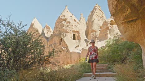 woman explores fairy chimney unique rocky landscape sunny day