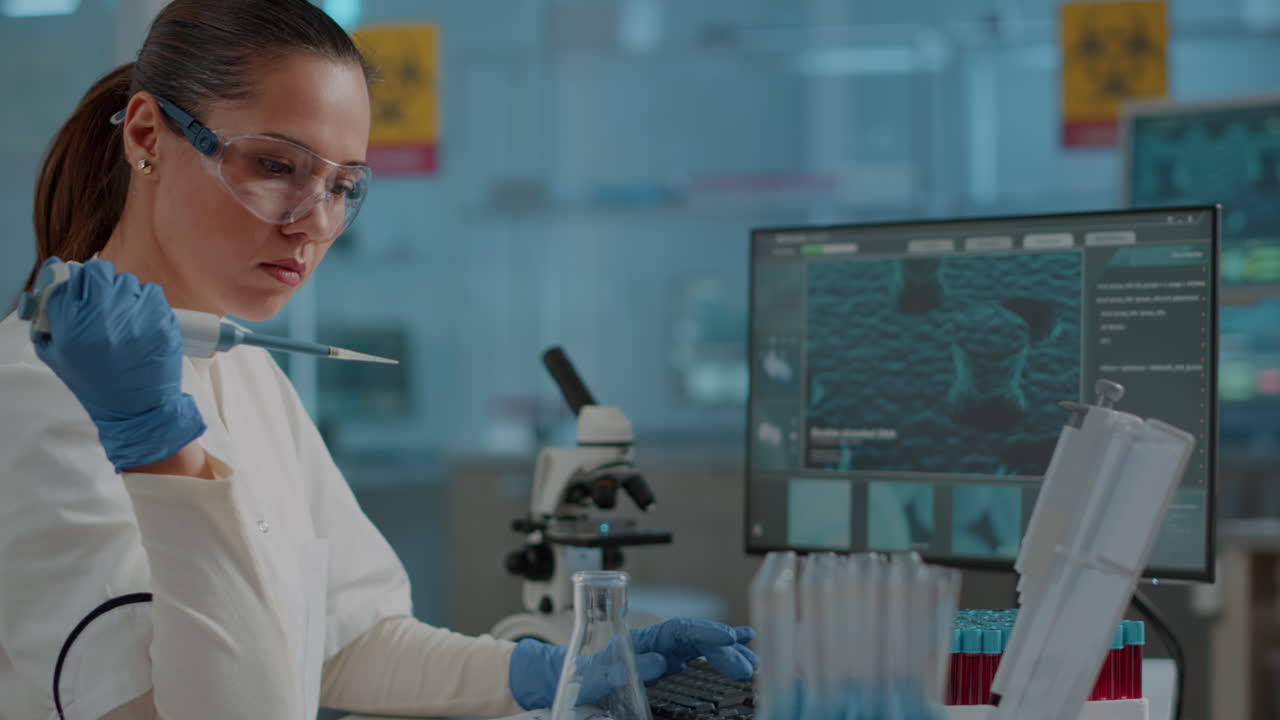 Chemist working on experiment with micro pipette and beaker