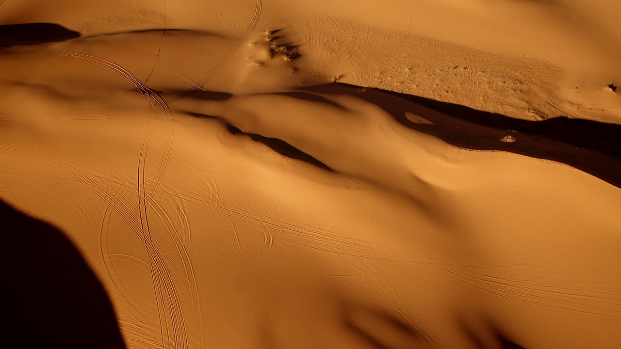 Surreal drone shot looking down on the interesting lines and shapes of the pink sand dunes state park in southern utah