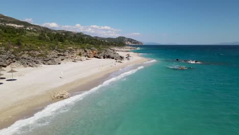 Drone-view-of-amazing-pacific-ocean-beach-surrounded-by-mountains