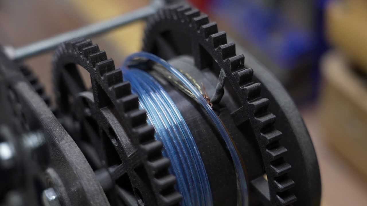 Mechanical gears in operation with a blue cable