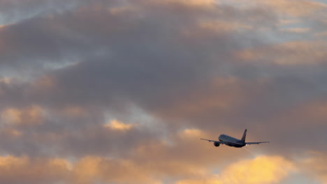 airplane flight in cloudy evening sky