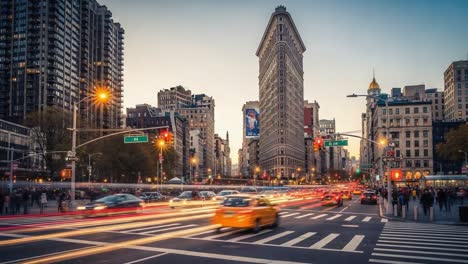 flatiron building and traffic at dusk in new york city