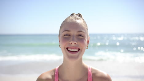 young caucasian woman smiles brightly on a sunny beach