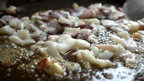 cuttlefish with garlic on friendose paellon in virgin olive oil in slow motion