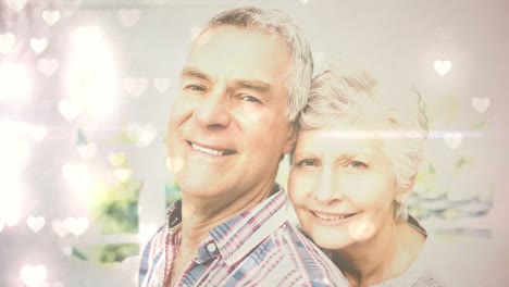 Linda-Pareja-De-Ancianos-Sonriendo-A-La-Cámara-Para-El-Día-De-San-Valentín-Con-Corazones