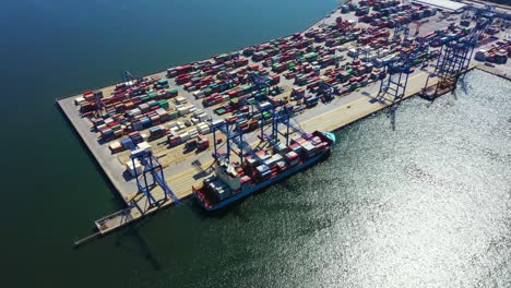 portacontenedores en importación, exportación y logística comercial, por grúa, puerto comercial, envío de carga al puerto, transporte internacional, concepto de logística comercial, vista aérea