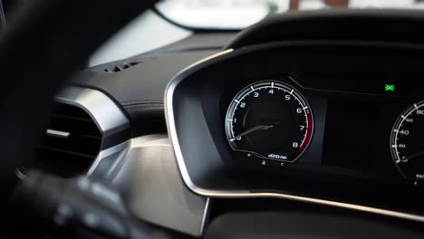 close up of car speed meter. interior of a modern car, dashboard with an engine speed dial and moving arrow