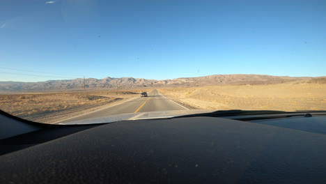 POV-Through-Windscreen-Driving-Along-Long-Empty-Desert-Road-Through-California