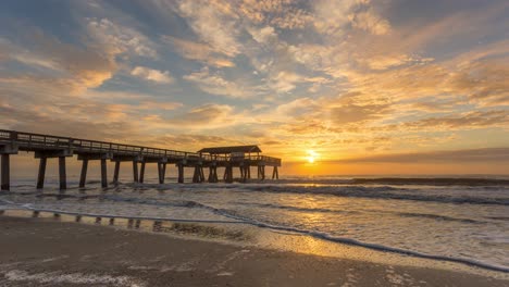 beautiful sunrise on the beach with tybee pier and pavilion