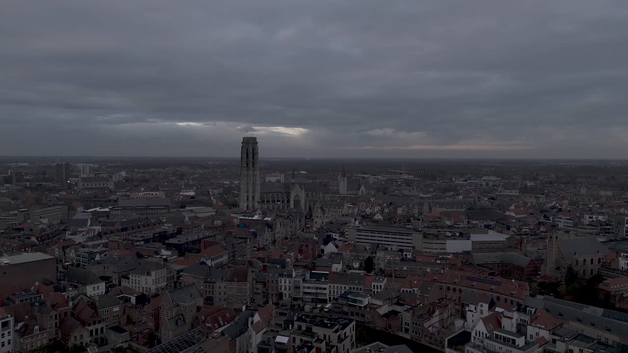Drone shot of a cathedral in the middle of the city before nightfall.