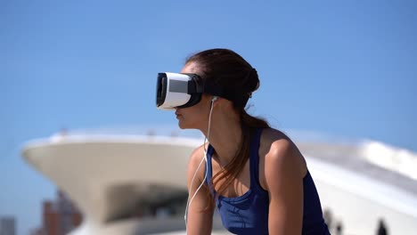 young woman using virtual reality headset outdoor