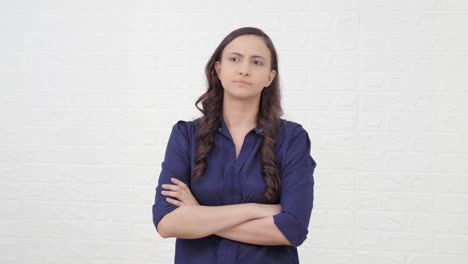 confident indian girl standing crossed hands