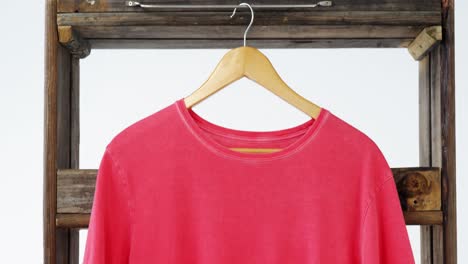 t-shirt hanging on a wooden frame