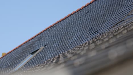 rooftop tiles and window on sunny day, close up view