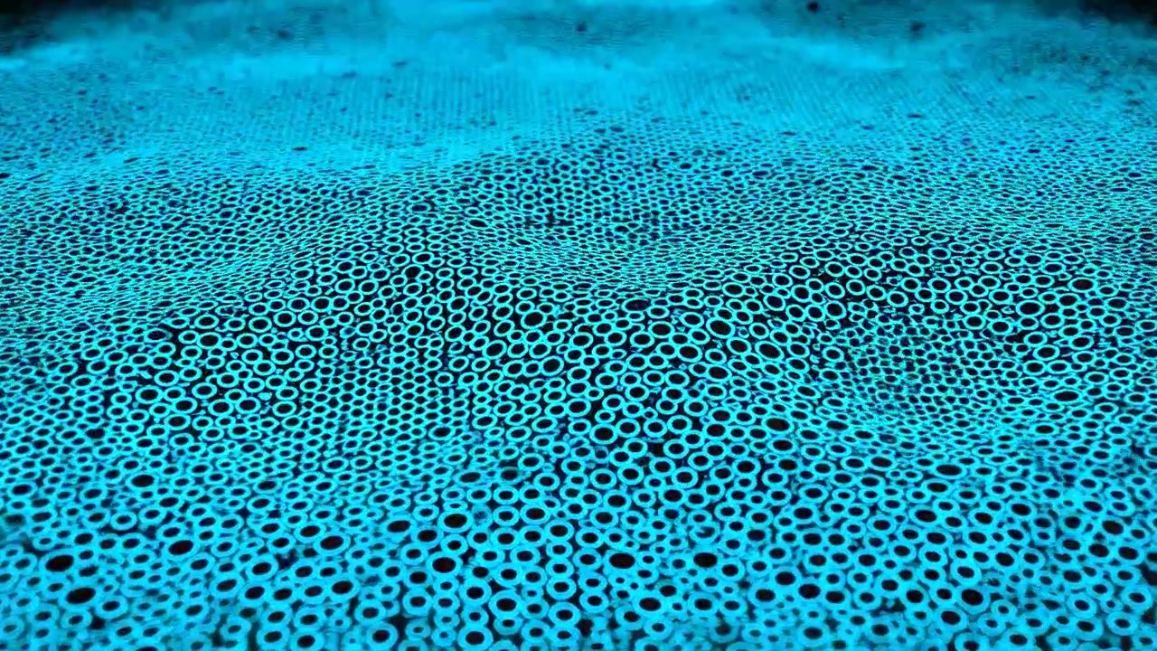 Thousands of blue glowing dots and rings drift over a dark abstract surface, forming a bright center with soft depth and a minimal futuristic mood