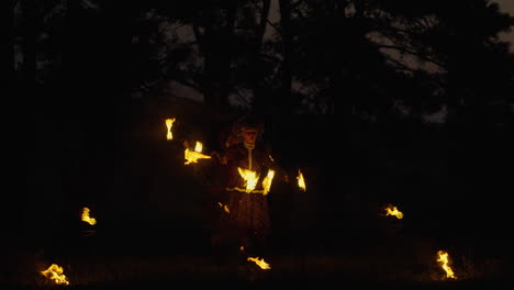 fire juggler in traditional costume at night
