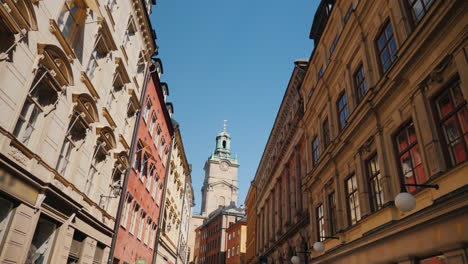 st nicholas (storkyrkan) bell tower in stockholm view through a narrow street with old houses 4k vid