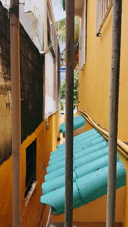 charming narrow alleyway with yellow buildings and green roof tiles