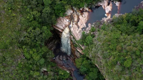 aerial drone dolly-out shot of the incredible mosquito falls surrounded by tropical jungle and cliffs in the chapada diamantina national park in northeastern brazil on a warm sunny summer day