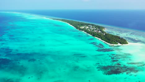 Vivid colors of great turquoise lagoon with coral reefs around tropical island in the middle of blue ocean on a misty morning