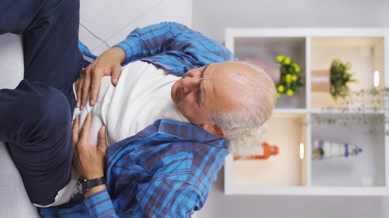 Vertical video of Old man with nausea.