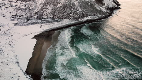 waves splashing at kvalvika beach during wintertime