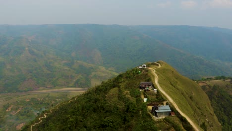 agriculture-farming-Fields-with-river-flowing-and-surrendered-by-mountain-at-morning-from-top-angle