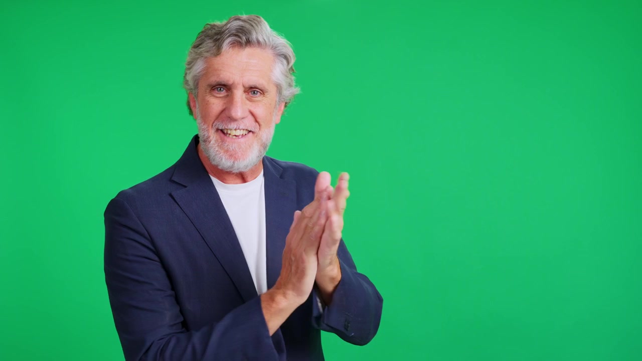 Senior businessman congratulating and clapping against a green screen