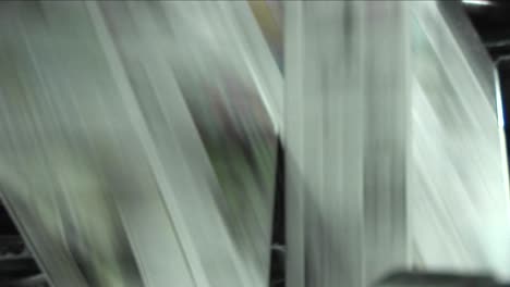 newspapers move along an assembly line in a factory 3