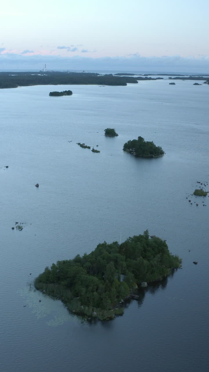 Vertical drone shot in front of islands in the archipelago, evening in Finland