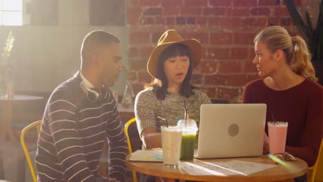 friends using laptop while having drink 4k