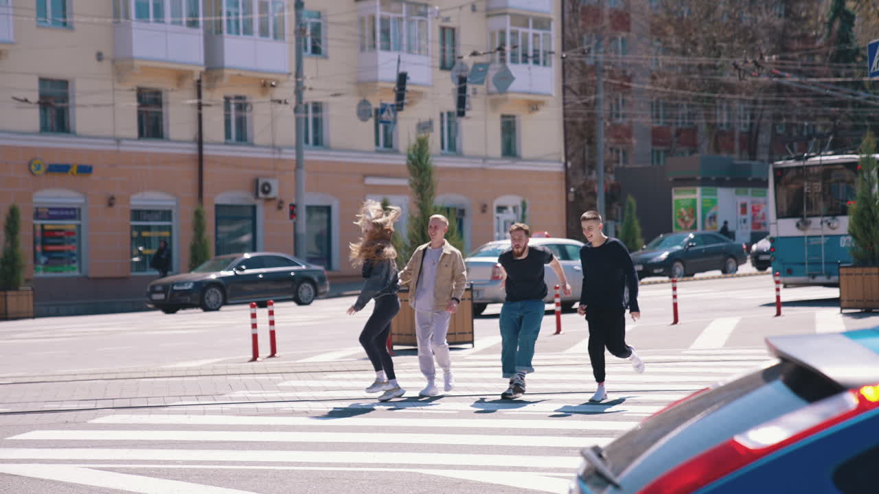 Modern friends in the street. Urban lifestyle. People emotionally running on the video. Friends running through the street. Aerial view