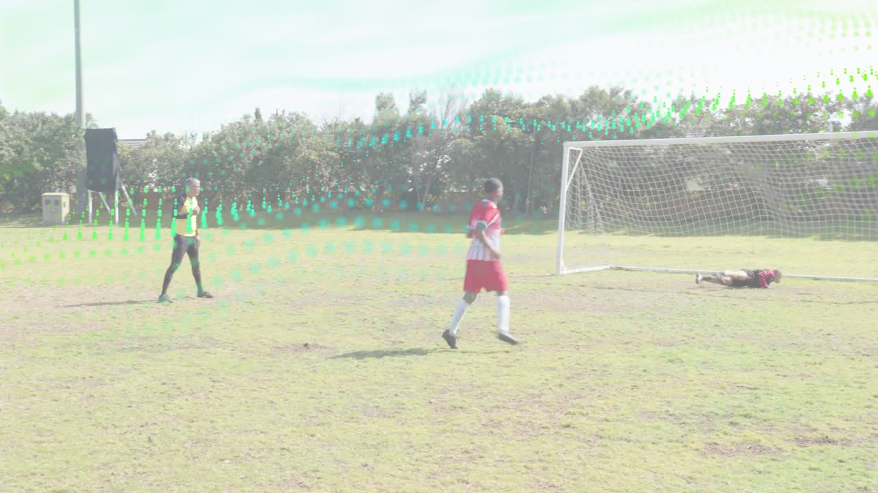 Training player placing ball on spot, official signaling go before kicking shot past diving keeper