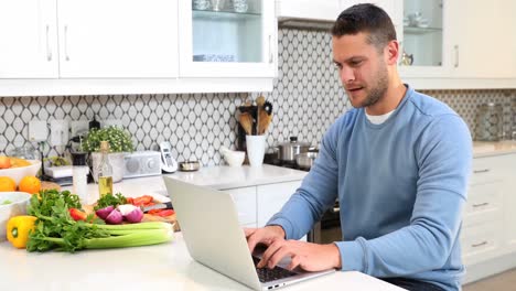 Happy-man-using-laptop-at-table-4k