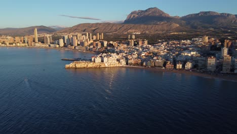 The-tourism-and-resort-beach-town-of-Benidorm,-Spain-and-Puig-Campana-Mountain---aerial