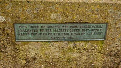 slow zoom in on the plaque on the cross of peace stating the wood was donated by queen elizabeth the 2nd