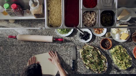 anonymous chef stretching dough for pastry