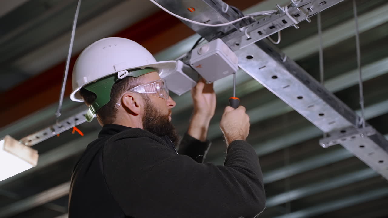 Electrician working on a ceiling fixture